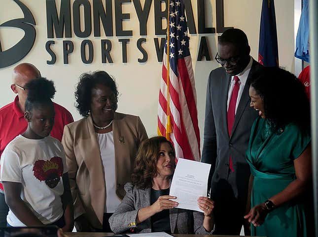 Michigan Gov. Gretchen Whitmer signs Crown Act legislation on Thursday, June 15, 2023 in Lansing, Mich. that will outlaw race-based hairstyle discrimination in workplaces and schools. State Sen. Sarah Anthony, far right, has pushed for the legislation since 2019. 