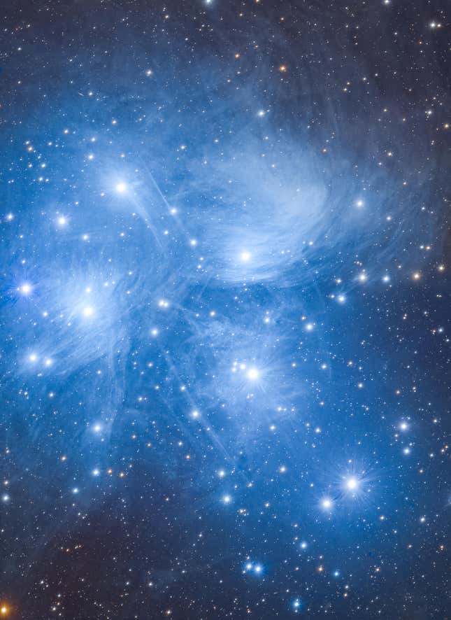 The Pleiades, a cluster of wisps and stars in the night sky.