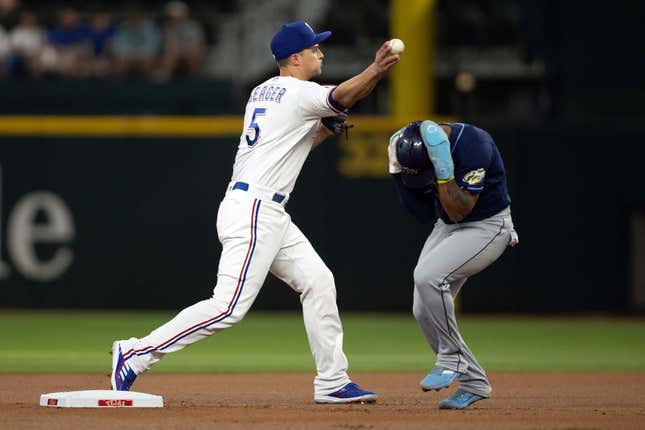 Jul 17, 2023; Arlington, Texas, USA; Texas Rangers shortstop Corey Seager (5) attempts to turn a double play as Tampa Bay Rays shortstop Wander Franco (5) runs to second base in the first inning at Globe Life Field.