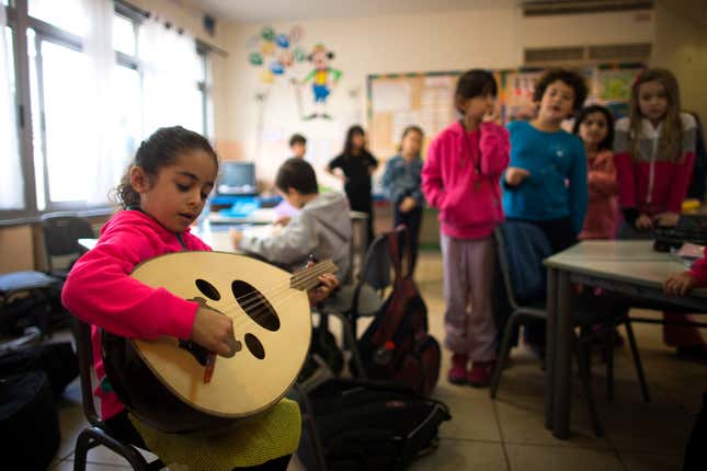 Mirvat, a second grade school girl, practises her Oud at an Arab Jewish bilingual school in Jerusalem.