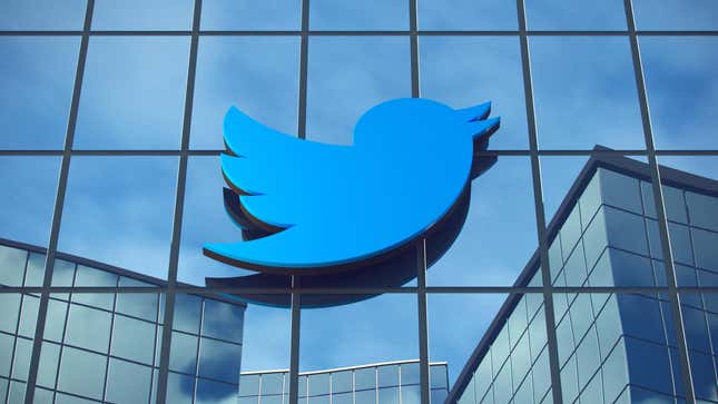 An image of the Twitter blue bird logo on a glass office building.
