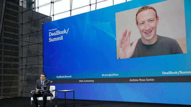 Mark Zuckerberg on a large screen waving to the camera.