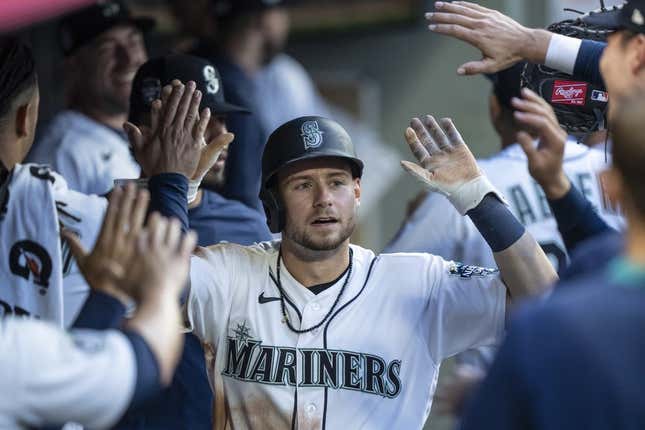 Jun 26, 2023; Seattle, Washington, USA; Seattle Mariners left fielder Jarred Kelenic (10) is congratulated by teammates in the dugout after scoring a run against the Washington Nationals during the fifth inning at T-Mobile Park.