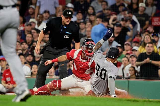 Sep 12, 2023; Boston, Massachusetts, USA; New York Yankees left fielder Everson Pereira (80) slides safe into home plate covered by Boston Red Sox catcher Connor Wong (12) during the fifth inning at Fenway Park.
