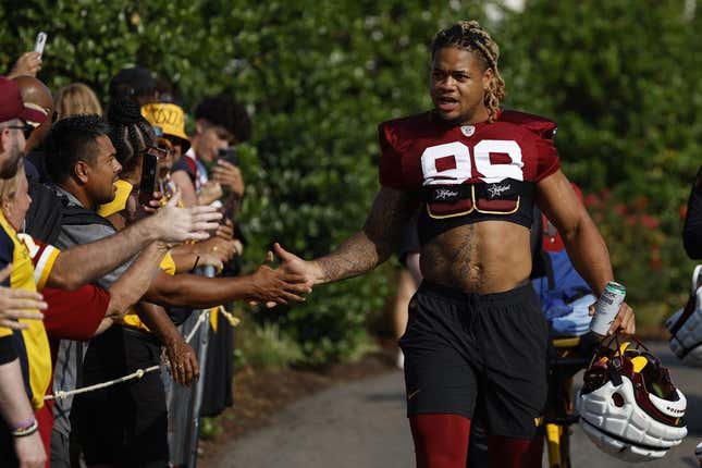 Jul 28, 2023; Ashburn, VA, USA; Washington Commanders defensive end Chase Young (99) shakes hands with fans while walking onto the fields prior to day three of Commanders training camp at OrthoVirginia Training Center.