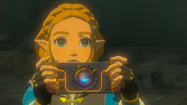 Princess Zelda holds up a device that looks like a Nintendo Switch.