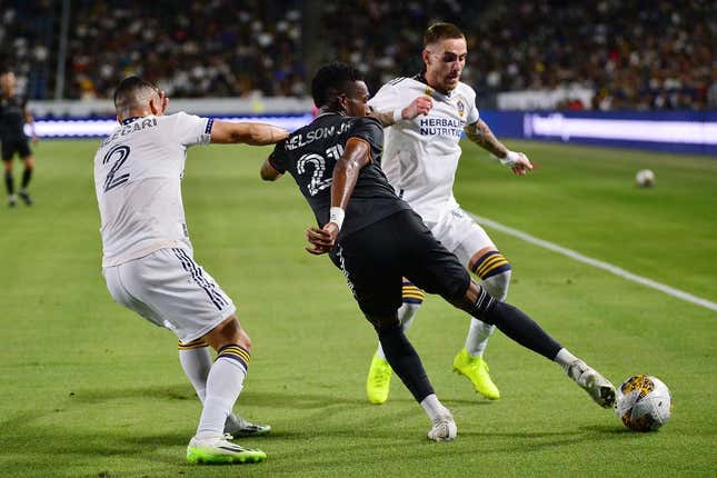 Sep 2, 2023; Carson, California, USA; Houston Dynamo forward Nelson Quinones (21) moves the ball against Los Angeles Galaxy defender Lucas Calegari (2) and midfielder Tyler Boyd (11) during the first half at Dignity Health Sports Park.