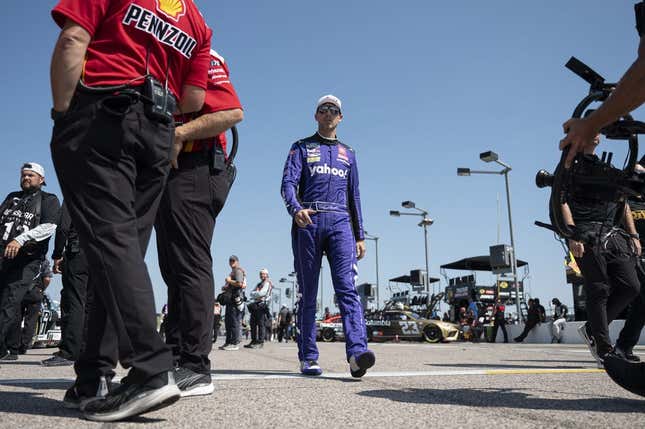Sep 9, 2023; Kansas City, Kansas, USA; NASCAR Cup Series driver Denny Hamlin (11) walks to his car during NASCAR Cup Qualifying at Kansas Speedway.