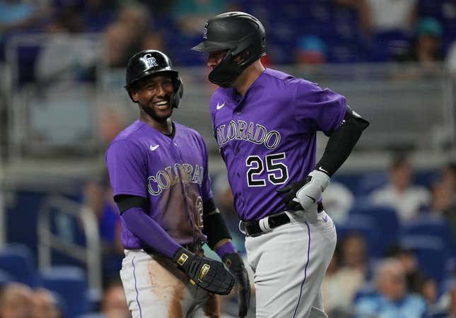 Jul 21, 2023; Miami, Florida, USA;  Colorado Rockies first baseman C.J. Cron (25) is congratulated by left fielder Jurickson Profar (29) after hitting a two-run home run in the first inning against the Miami Marlins at loanDepot Park.