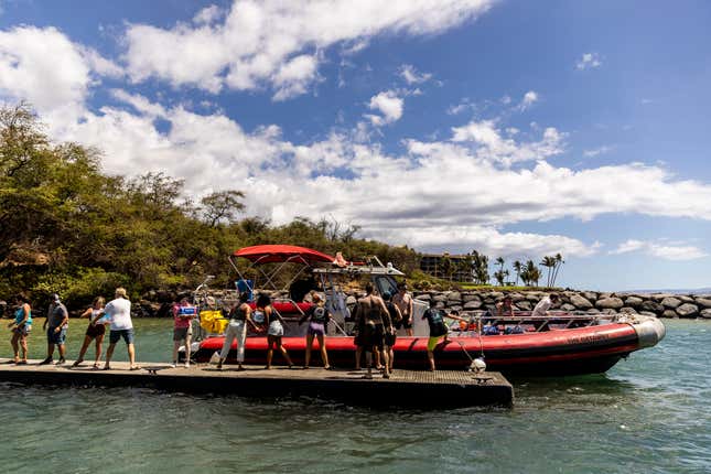 Volunteers load supplies onto a boat for West Maui at the Kihei boat landing, after a wildfire destroyed much of the historical town of Lahaina, on the island of Maui, Hawaii on August. 13, 2023.