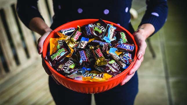 Hands holding bowl of Halloween candy