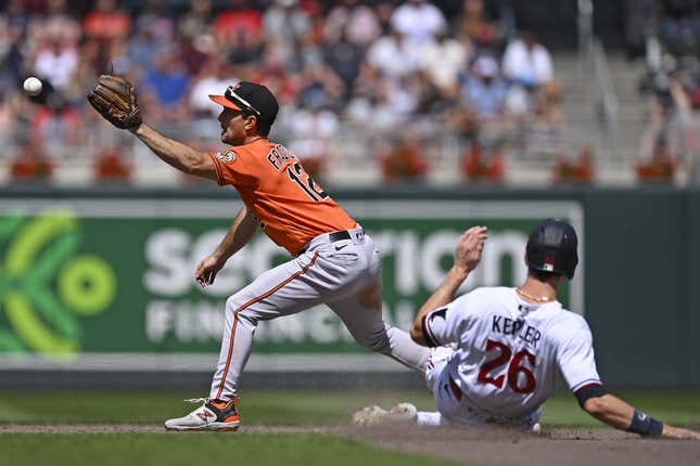 Jul 8, 2023; Minneapolis, Minnesota, USA;  Baltimore Orioles infielder Adam Frazier (12) catches a ball to force out Minnesota Twins outfielder Max Kepler (26) during the eighth inning at Target Field.