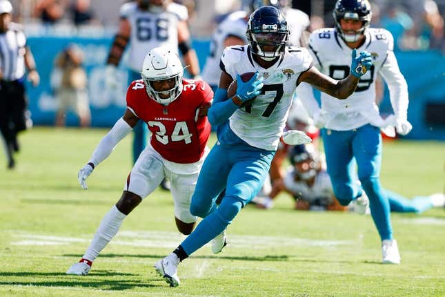 Sep 26, 2021; Jacksonville, Florida, USA;  Jacksonville Jaguars wide receiver D.J. Chark (17) runs with the ball while being chased by Arizona Cardinals defensive back Jalen Thompson (34) in the fourth quarter at TIAA Bank Field.