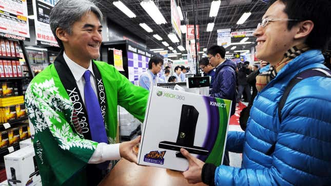 Pictured is a customer receiving an Xbox 360 at a Tokyo retailer.  
