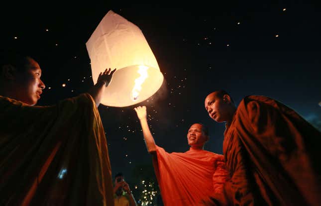 Thai Buddhist monks release lanterns in Bangkok.