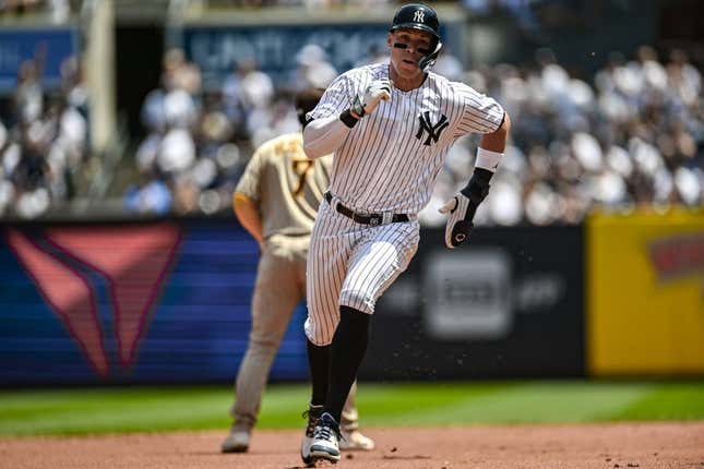 May 27, 2023; Bronx, New York, USA; New York Yankees center fielder Aaron Judge (99) advances to third base on a single by New York Yankees first baseman Anthony Rizzo (48) during the first inning against the San Diego Padres at Yankee Stadium.