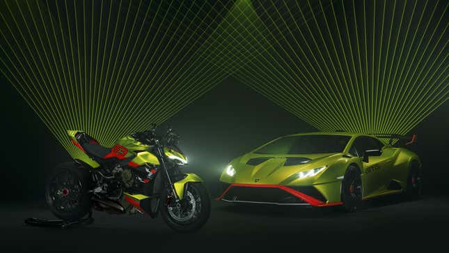 A Lamborghini Huracan STO and a Ducati Streetfighter Lamborghini enjoy a laser show.