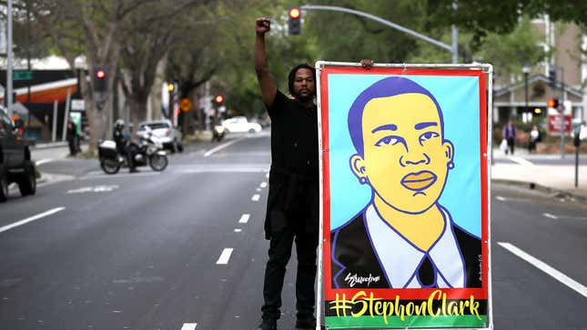  Black Lives Matter protester holds an illustration of Stephon Clark during a march and demonstration through the streets of Sacramento, Calif., on April 4, 2018.