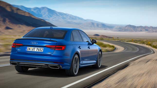 A photo of a blue Audi A4 sedan driving on a highway. 