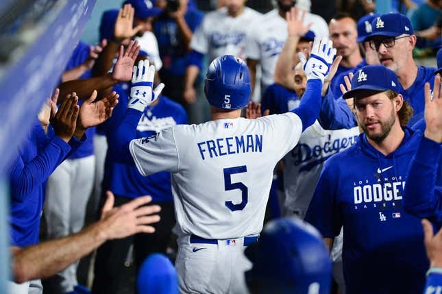 Sep 12, 2023; Los Angeles, California, USA; Los Angeles Dodgers first baseman Freddie Freeman (5) is greeted after hitting a two run home run against the San Diego Padres during the third inning at Dodger Stadium.