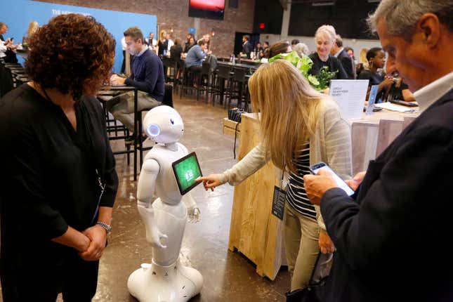 Guests interact with Pepper the robot during the 2017 New Yorker TechFest at Cedar Lake on October 6, 2017 in New York City. 