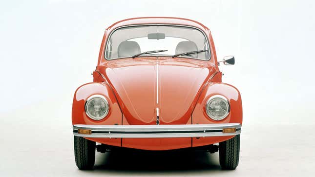 A photo of the front of a red Volkswagen Beetle. 