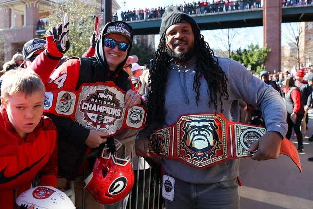 Jan 14, 2023; Athens, GA, USA; Georgia Bulldogs fan and assistant coach Jarvis Jones hold belts at the national championship celebration at Sanford Stadium.