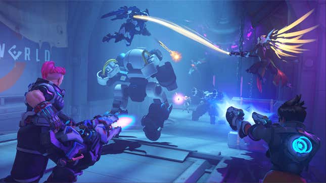 A screenshot from the new Overwatch 2 Underworld mode, a free PvE mode kicking off with Invasion. Zarya, Tracer, Mercy, and Pharah are escorting a robot down a hallway and fighting omnics.