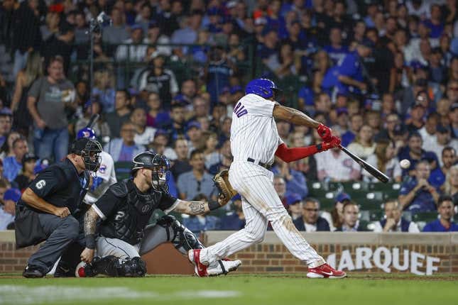 Aug 15, 2023; Chicago, Illinois, USA; Chicago Cubs third baseman Jeimer Candelario (9) singles against the Chicago White Sox during the sixth inning at Wrigley Field.