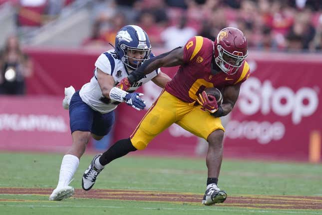 Sep 2, 2023; Los Angeles, California, USA; Southern California Trojans running back MarShawn Lloyd (0) carries the ball against Nevada Wolf Pack defensive back Ezekiel Robbins (13) in the first half at United Airlines Field at Los Angeles Memorial Coliseum.