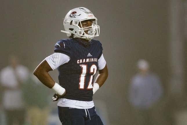 Chaminade-Madonna&#39;s Zaquan Patterson (12) walks off the field to meet with his team during a timeout. Chaminade-Madonna shutout Berkeley Prep 21-0 to claim the 3A State Championship title at Gene Cox Stadium on Friday, Dec. 10, 2021.

Second Half Chaminade Madonna V Bp 021