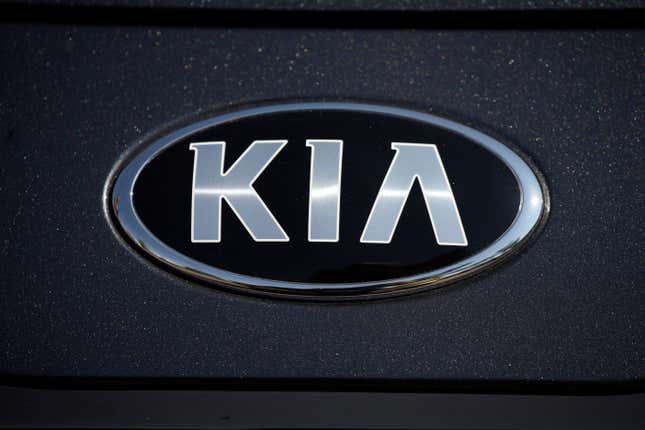 FILE - The company logo shines off the hood of a 2021 K5 sedan on display in the Kia exhibit at the Denver auto show Friday, Sept. 17, 2021, at Elitch&#39;s Gardens in downtown Denver. Kia is recalling about 320,000 cars in the U.S. to fix a problem that could stop the trunk from being opened from the inside, Thursday, Aug. 31, 2023. The recall covers the Optima midsize car from 2016 through 2018, Optima hybrids and plug-ins from 2017 and 2018, and the Rio small car from 2016 and 2017. (AP Photo/David Zalubowski, File)