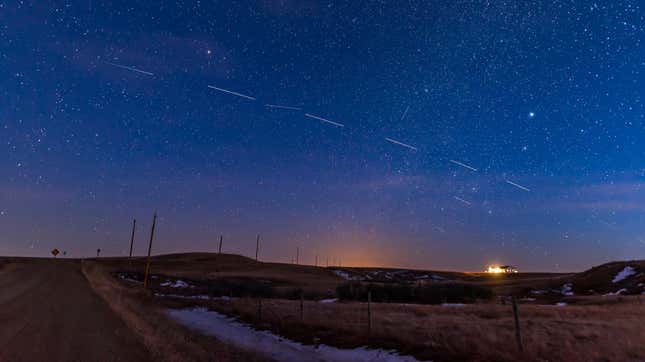 Four trains of Starlink satellites can be seen in the sky. They look like silver streaks.