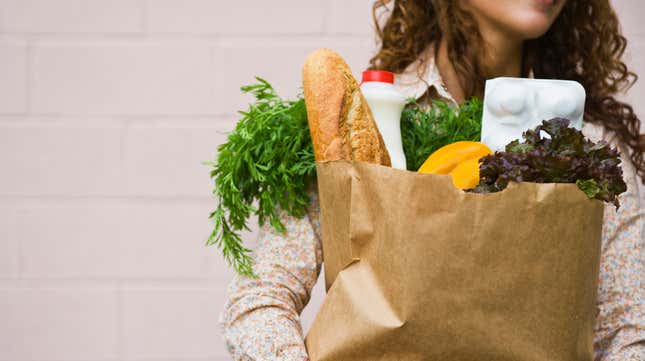 woman holding bag of groceries