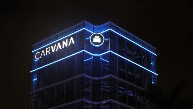 A photo of the Carvana tower illuminated at night. 
