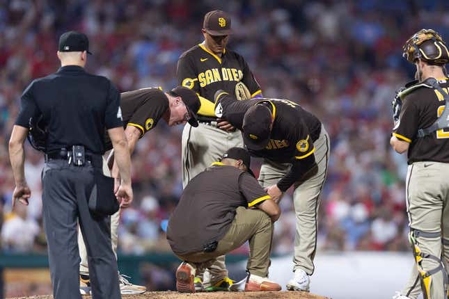 Jul 15, 2023; Philadelphia, Pennsylvania, USA; San Diego Padres relief pitcher Adrian Morejon (50) is tended to by a trainer after an apparent injury during the sixth inning against the Philadelphia Phillies at Citizens Bank Park.