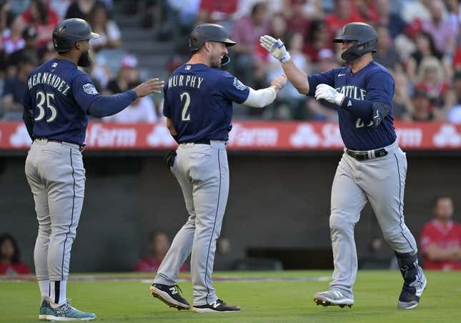 Aug 4, 2023; Anaheim, California, USA;  Seattle Mariners first baseman Ty France (23) is greeted by right fielder Teoscar Hernandez (35) and catcher Tom Murphy (2) after hitting a three run home run in the first inning against the Los Angeles Angels at Angel Stadium.