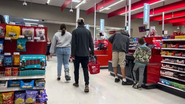 Shoppers heading to available self-checkout kiosk