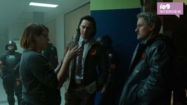 Director Kate Herron talks to Tom Hiddleston and Owen Wilson on the set of Marvel's Loki.