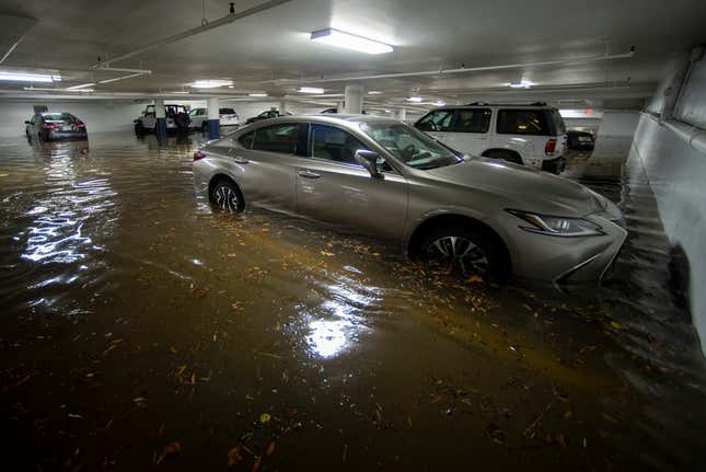 An underground parking garage floods as the Potomac River overflows its  banks in the historic Old Town section of Alexandria, Va., Friday, Oct.  29, 2021.