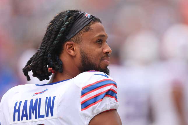 Buffalo Bills safety Damar Hamlin looks over his shoulder at something while standing on the sidelines of an NFL game against the Chicago Bears