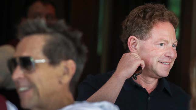 Bobby Kotick awkwardly scratches his neck at an event.