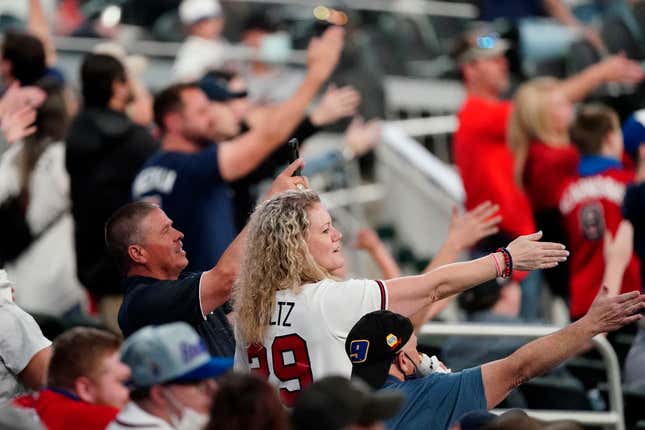  Braves fans perform the team’s trademark “Tomahawk Chop”.