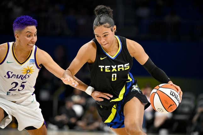 Jul 22, 2023; Arlington, Texas, USA; Dallas Wings forward Satou Sabally (0) drives to the basket past Los Angeles Sparks guard Layshia Clarendon (25) during the second quarter at College Park Center.