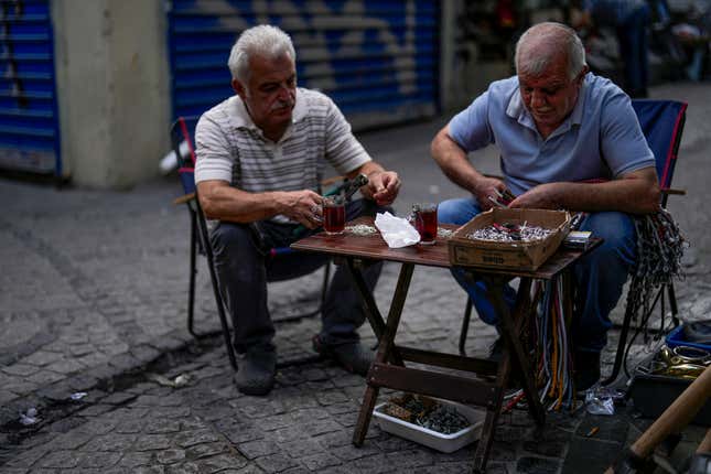 Two men work with some items outside a hardware store at Eminonu commercial district in Istanbul, Turkey, Wednesday, Sept. 6, 2023. Turkish President Recep Tayyip Erdogan, who has espoused unconventional policies in the past, is fully on board with the country's new economic policies that foresee a tight monetary policy to bring down inflation, members of his economy team said Thursday. (AP Photo/Francisco Seco)