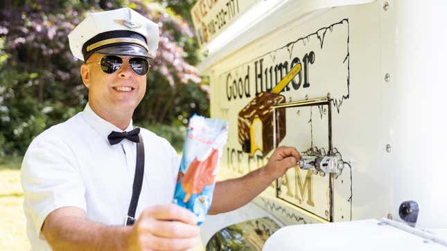 Good humor ice cream truck vendor handing customer a frozen novelty