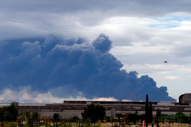 Billowing smoke from the Sesena fire is seen from a distance.