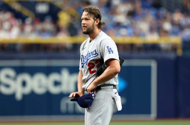 May 27, 2023; St. Petersburg, Florida, USA; Los Angeles Dodgers starting pitcher Clayton Kershaw (22) reacts after he balked and puts the transmitter in his hat during the first inning against the Tampa Bay Rays  at Tropicana Field.
