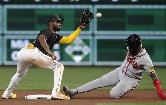 Aug 7, 2023; Pittsburgh, Pennsylvania, USA; Atlanta Braves designated hitter Marcell Ozuna (right) steals second base as Pittsburgh Pirates second baseman Liover Peguero (left) takes the throw during the sixth inning at PNC Park.
