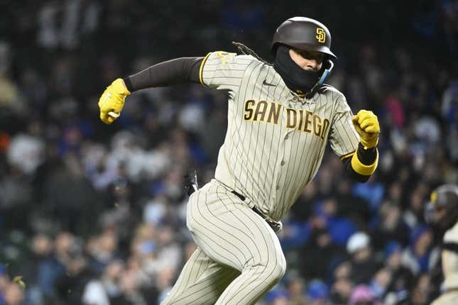 Apr 26, 2023; Chicago, Illinois, USA;  San Diego Padres right fielder Fernando Tatis Jr. (23) runs to first after he hits a two RBI single against the Chicago Cubs during the seventh inning at Wrigley Field.